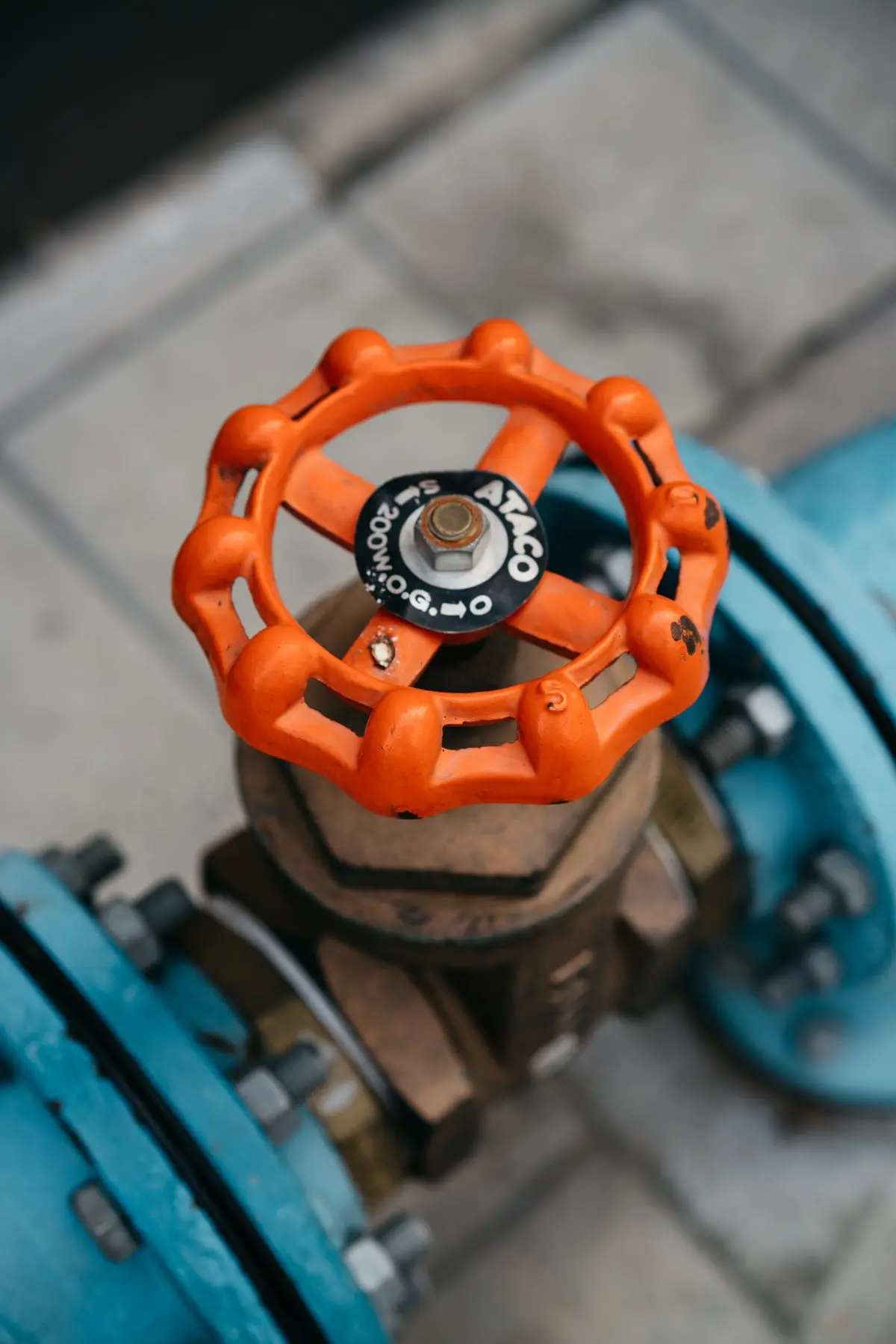 Orange water valve on a blue pipe